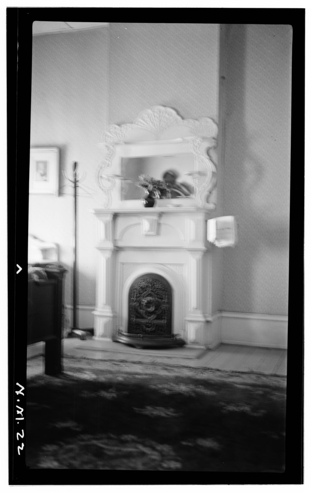 An archival architectural photograph of a fireplace and mantel inside the St. James Hotel.